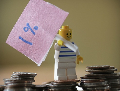 Lego Man holding 1 percent flag.